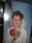 Me when I was way younger...LOL:P  I'm in my Tae Kwondo Outfit Holding up a Silver Medal, from the tournament.