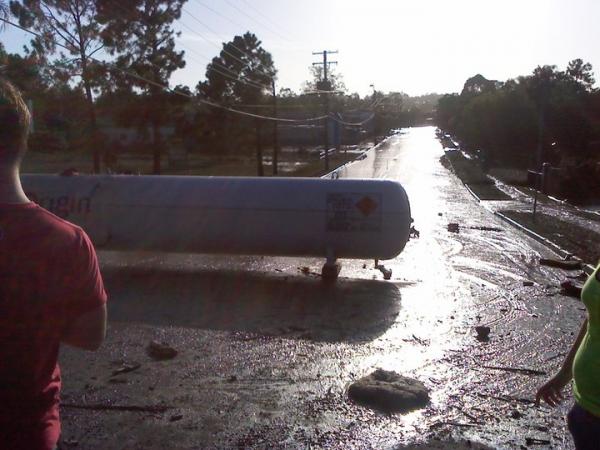 This gas tank is from down the end of our street. It ended up right in front of the entrance to our units. This was 3 days after the flood waters went down. The roads were COVERED in mud.